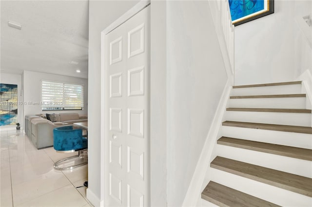 stairs featuring tile patterned floors