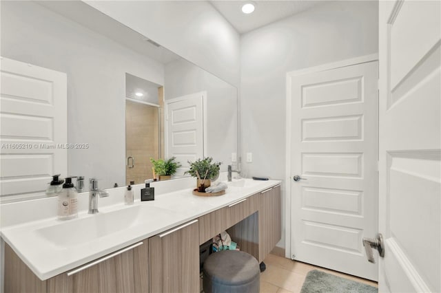 bathroom featuring tile patterned flooring, vanity, and a shower with door