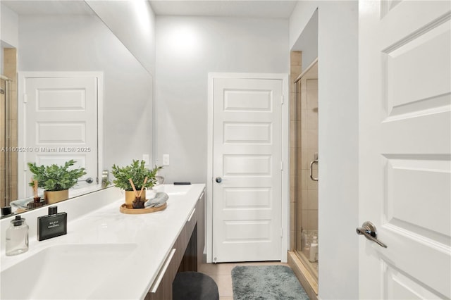 bathroom with vanity, a shower with shower door, and tile patterned floors