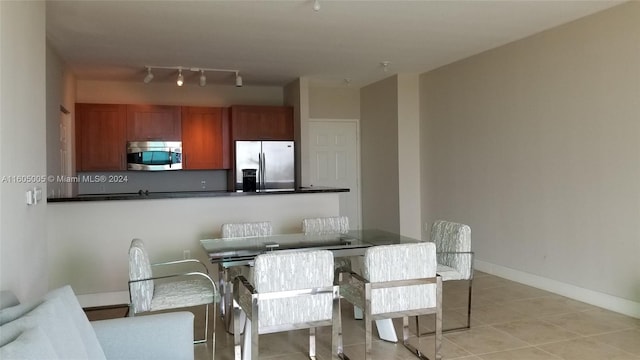 dining space featuring light tile patterned floors