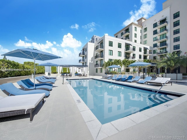 view of swimming pool with a patio area and a pergola