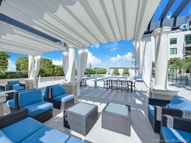 view of patio with outdoor lounge area and a community pool