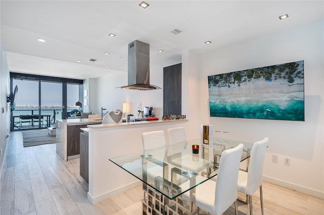 dining space featuring light hardwood / wood-style floors and floor to ceiling windows