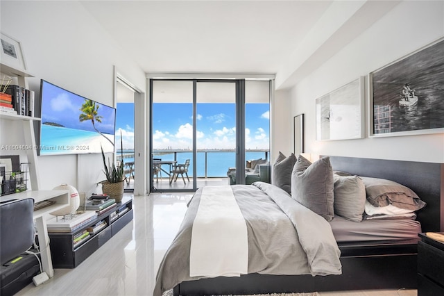 tiled bedroom featuring access to outside, a wall of windows, and a water view