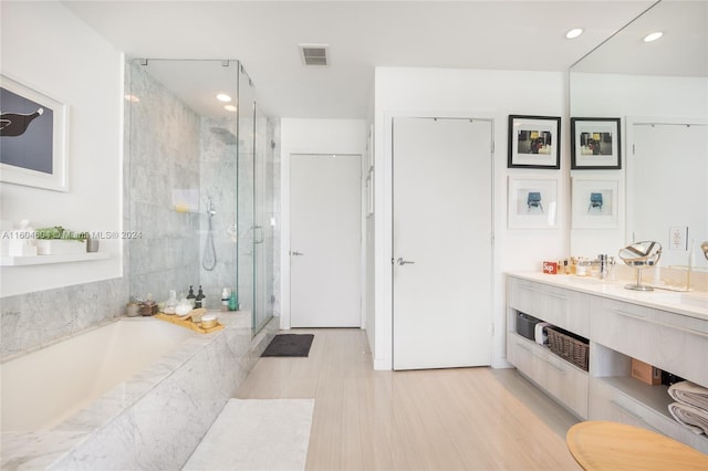 bathroom featuring tile floors, shower with separate bathtub, and vanity with extensive cabinet space