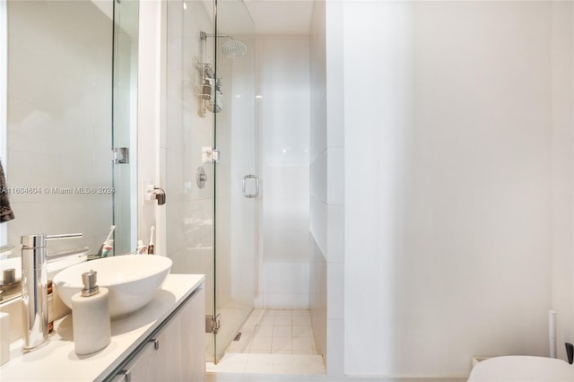 bathroom featuring vanity, toilet, and a shower with door