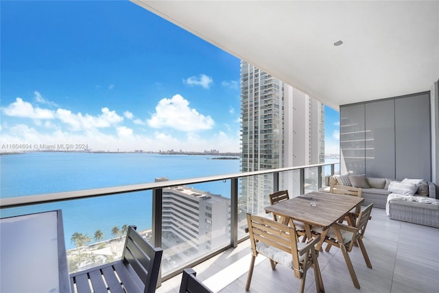 balcony featuring a water view and an outdoor hangout area