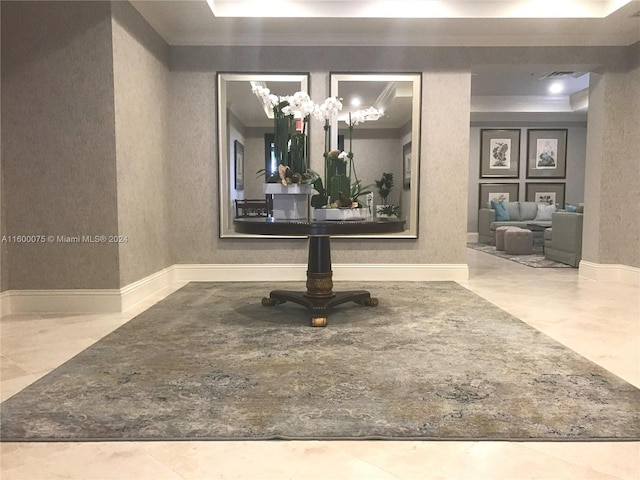 interior space with a tray ceiling, a notable chandelier, and tile floors