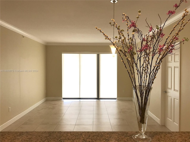 tiled empty room with a healthy amount of sunlight and ornamental molding