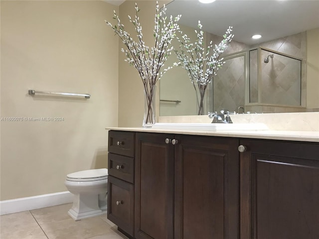 bathroom featuring vanity, toilet, and tile floors