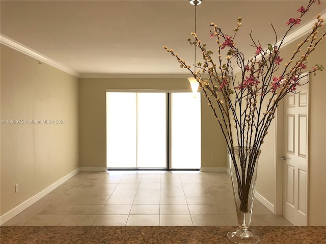 tiled spare room featuring ornamental molding