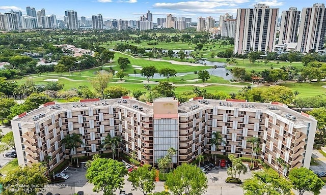 aerial view with a water view, a view of city, and golf course view