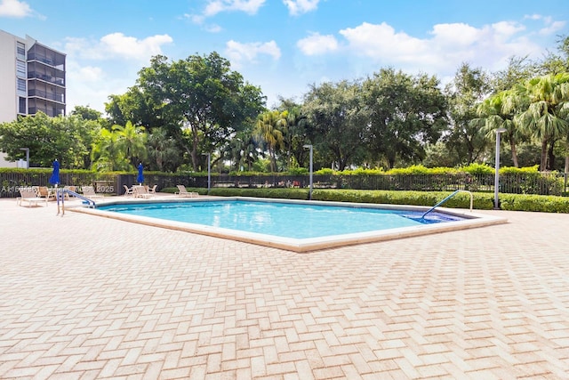 pool featuring a patio area and fence