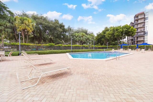 community pool featuring a patio area and fence