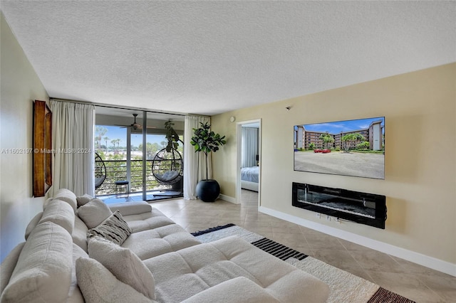 living room featuring light tile patterned floors, a textured ceiling, and floor to ceiling windows