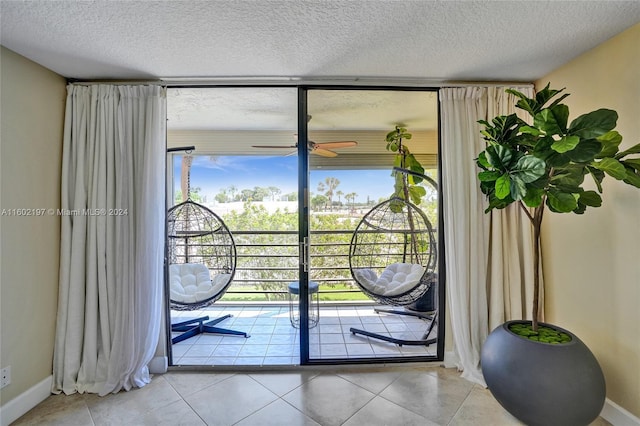 doorway with light tile patterned flooring, floor to ceiling windows, and ceiling fan