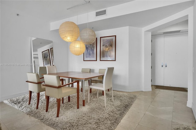 dining space with light tile floors