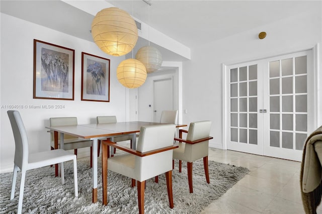 tiled dining area featuring french doors