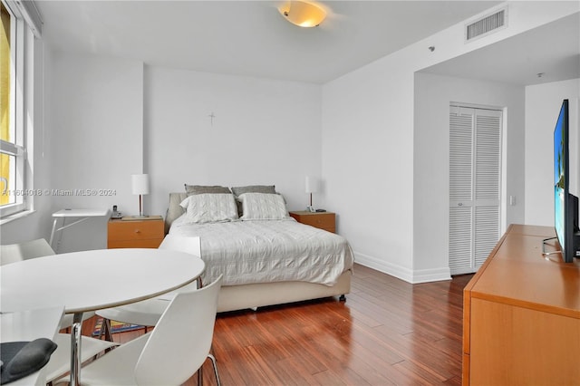 bedroom with a closet and hardwood / wood-style flooring