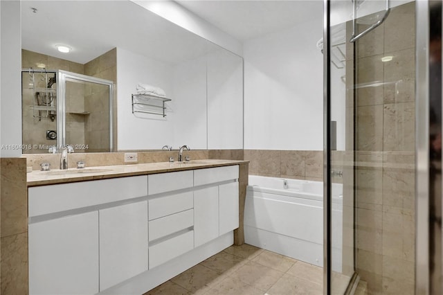 bathroom featuring shower with separate bathtub, dual vanity, and tile floors