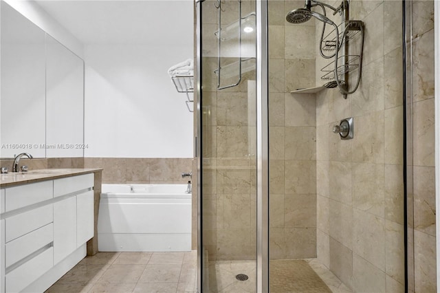 bathroom featuring independent shower and bath, vanity, and tile flooring