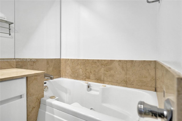 bathroom with a bath to relax in and tile walls