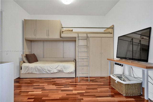 bedroom with hardwood / wood-style flooring