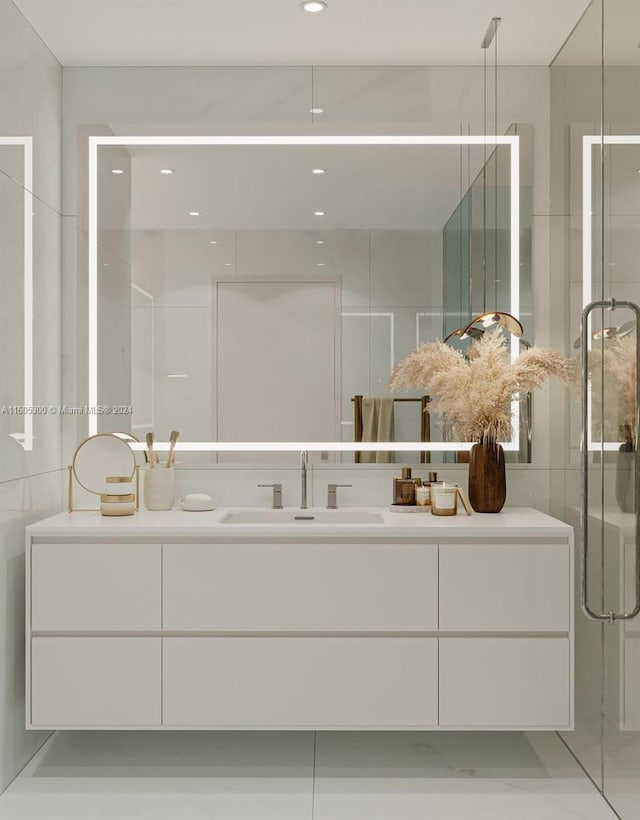 bathroom featuring vanity and a shower with door