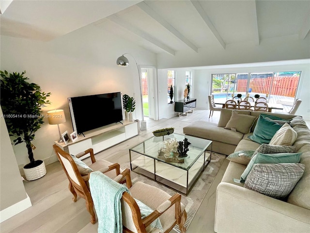 living room featuring beam ceiling and light hardwood / wood-style flooring