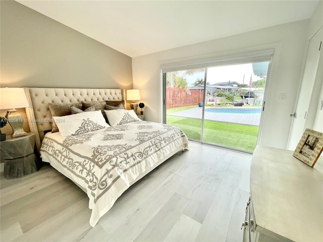 bedroom with access to outside and wood-type flooring