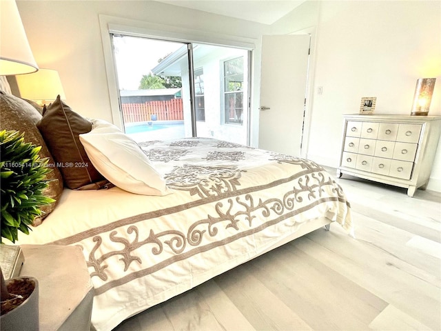 bedroom featuring access to exterior and light hardwood / wood-style flooring