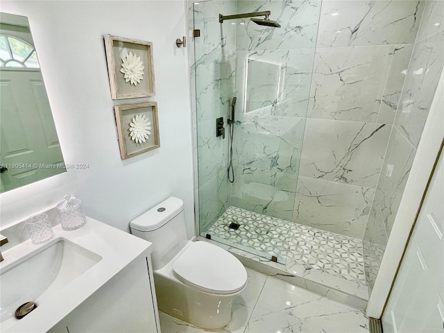 bathroom with toilet, vanity, and tiled shower