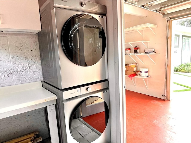 laundry room with stacked washer / dryer