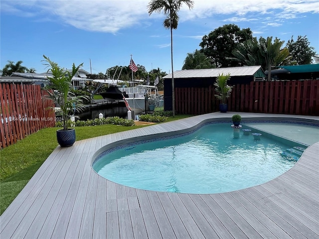 view of pool featuring a deck with water view