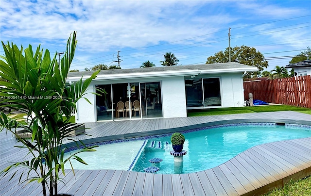 view of swimming pool with a wooden deck