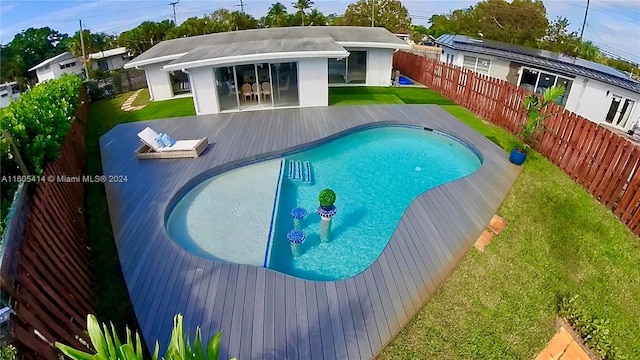 view of pool featuring a lawn and a patio area