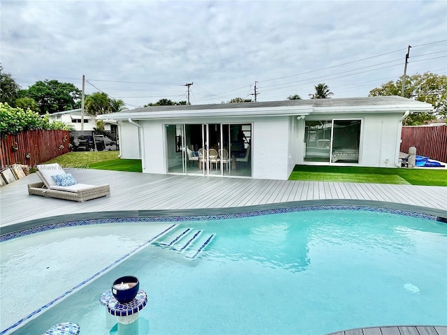 view of pool featuring a deck and a yard