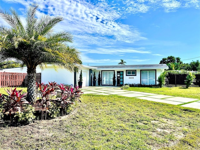 view of front of property with a garage and a front yard