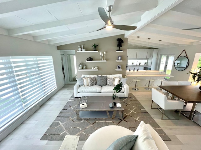 living room with ceiling fan, lofted ceiling with beams, and light hardwood / wood-style flooring