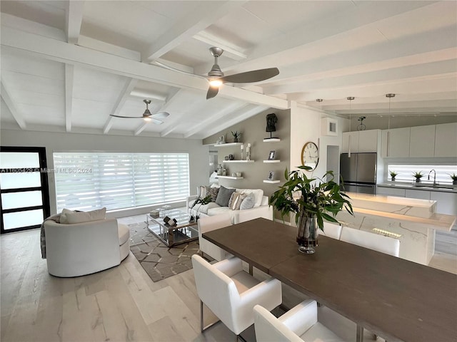 dining room featuring sink, lofted ceiling with beams, ceiling fan, and light hardwood / wood-style flooring