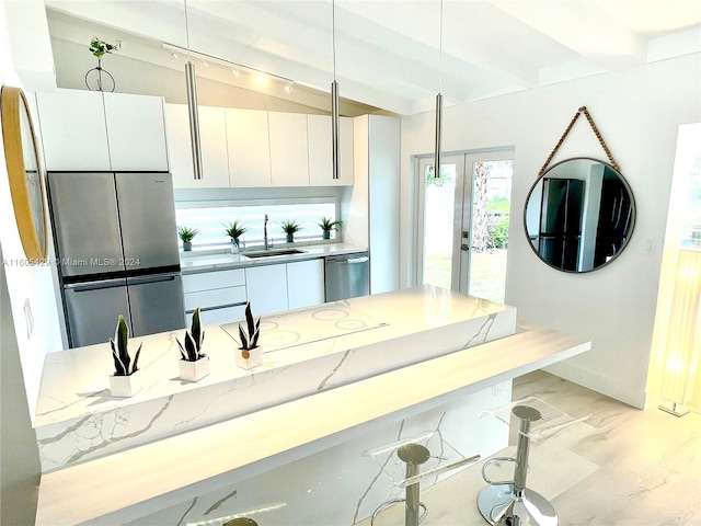 kitchen with light hardwood / wood-style floors, stainless steel appliances, track lighting, white cabinets, and sink