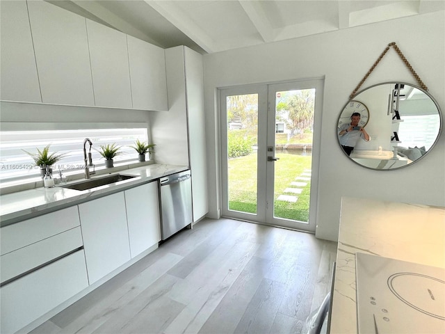 kitchen featuring light hardwood / wood-style floors, french doors, stainless steel dishwasher, sink, and white cabinets