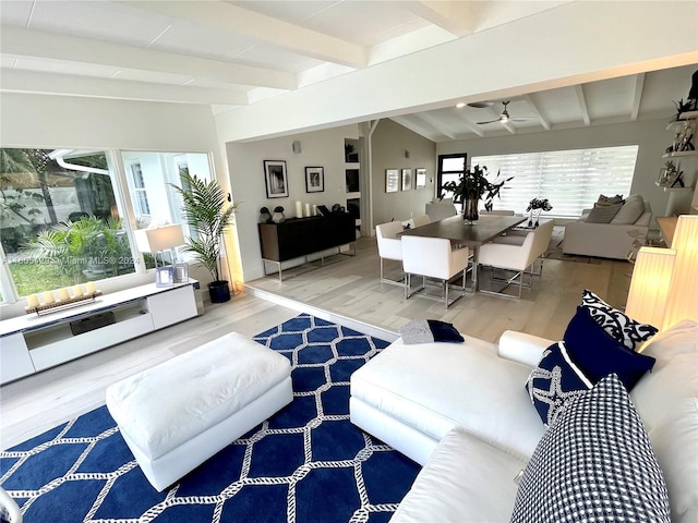 living room featuring lofted ceiling with beams, ceiling fan, and hardwood / wood-style floors