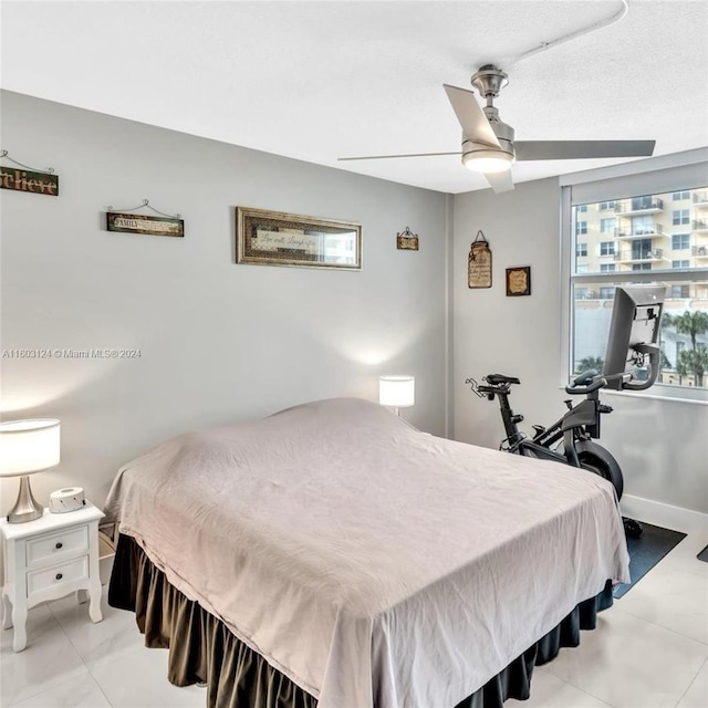 bedroom with light tile patterned floors and ceiling fan