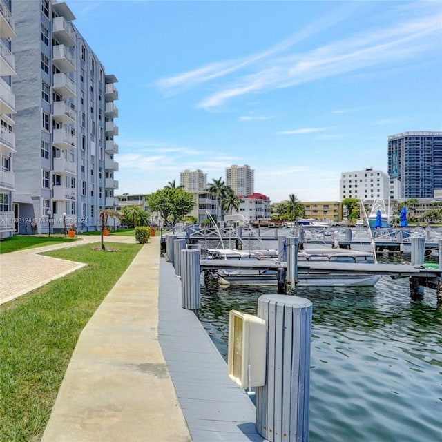 dock area featuring a lawn and a water view