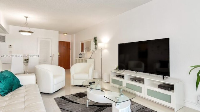 tiled living room with a textured ceiling