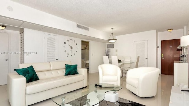 tiled living room with a textured ceiling