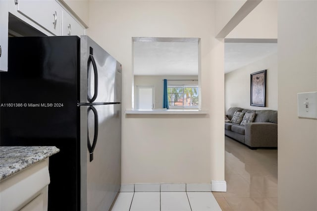 tiled living room with a wall mounted air conditioner