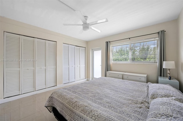 bedroom with ceiling fan and multiple closets