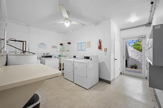 laundry room featuring ceiling fan, water heater, light tile patterned flooring, and washer and clothes dryer